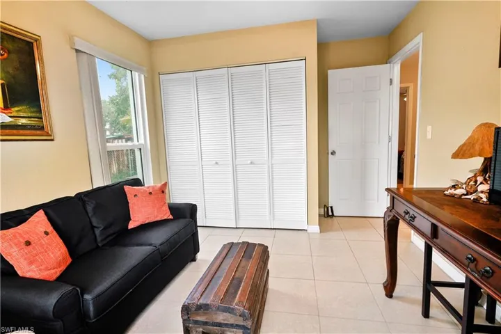 Bedroom / den Living room featuring light tile patterned floors