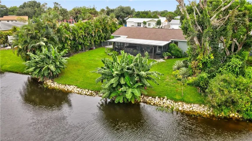 Bird's eye view with a water view of private back yard and screened lania.