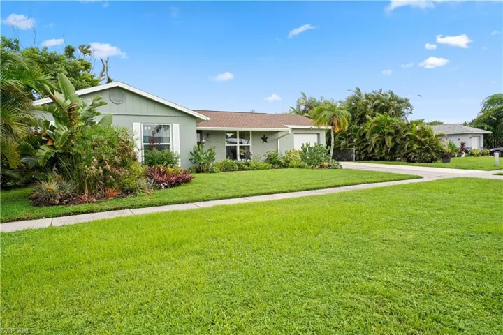 Ranch-style home featuring a front yard