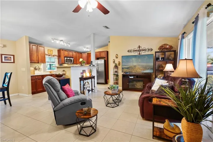 Neutral large tile floors. Great open floor plan, the valuted ceiling adds to the spaciousness.