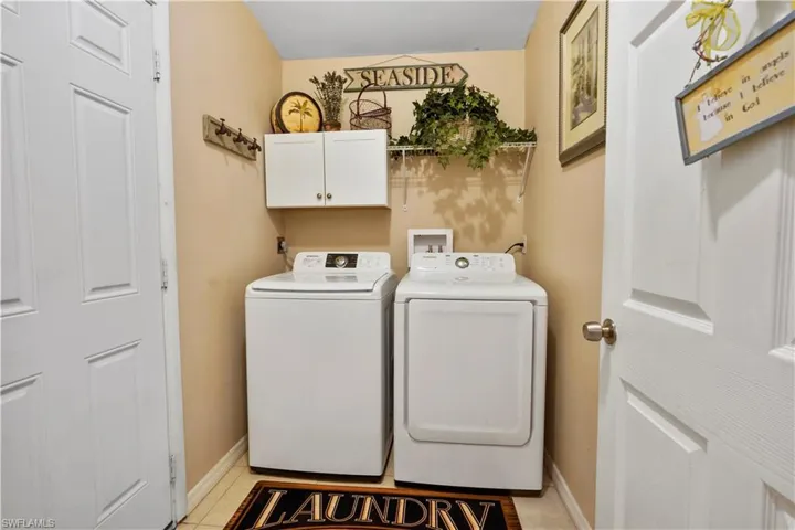 Inside laundry room, is a huge plus! Washer and dryer stay includes  cabinets to keep organized.
