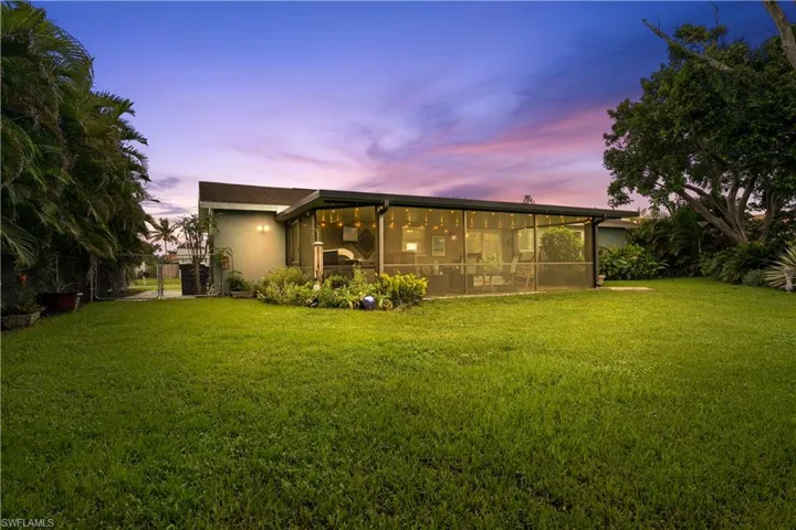 Back house at dusk, very private with mature trees. You'll love the lake view!