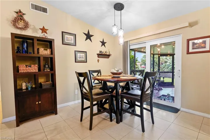 Dining area with light tile patterned flooring