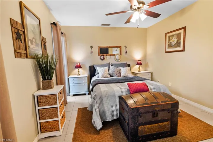 Bedroom featuring light tile patterned flooring and ceiling fan