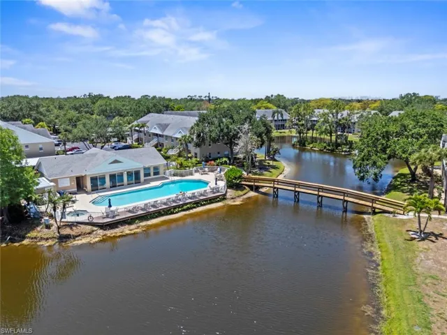 Community amenities featuring a central pool, a spa, and sun loungers