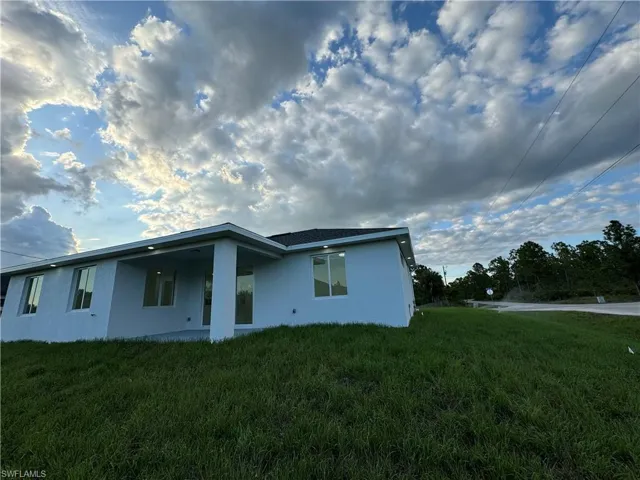 View of property exterior with a lawn