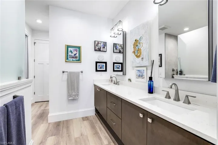 Bathroom with hardwood / wood-style floors and dual bowl vanity