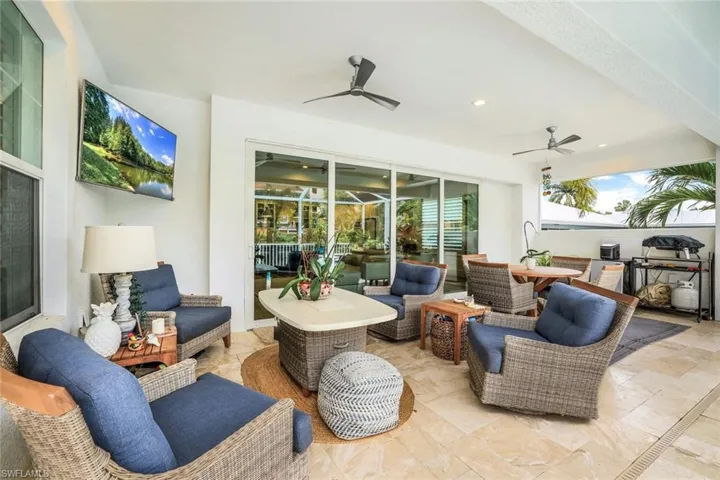 View of patio with an outdoor living space and ceiling fan