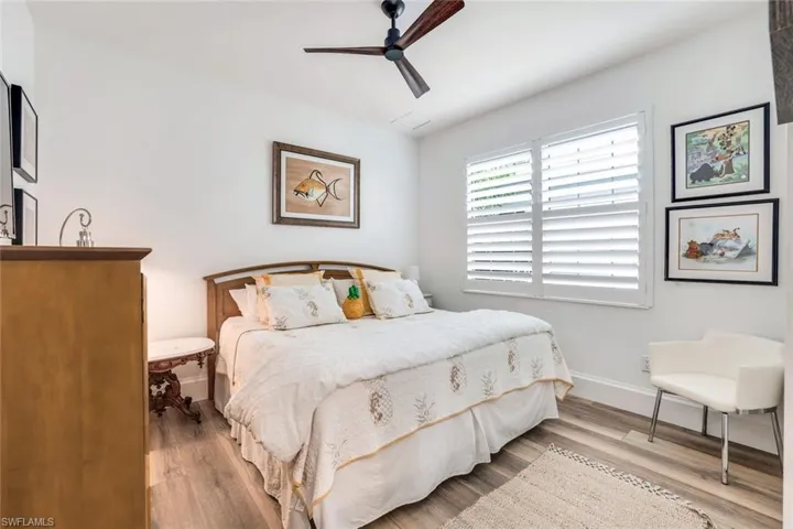 Bedroom with ceiling fan and light hardwood / wood-style flooring