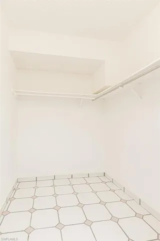 Spacious closet featuring tile floors