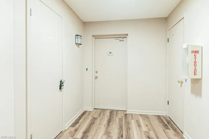 Doorway featuring light hardwood floor/ plus storage unit