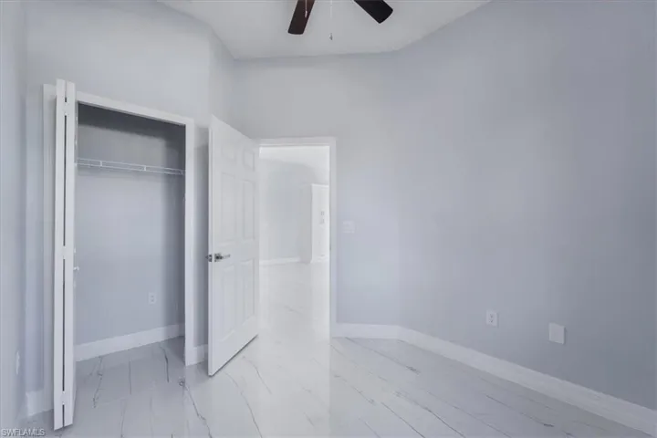 Unfurnished bedroom with a closet and ceiling fan