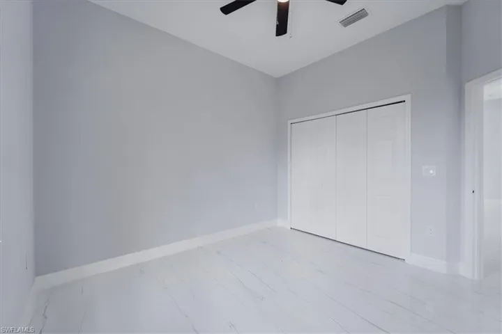 Unfurnished bedroom featuring a closet and ceiling fan