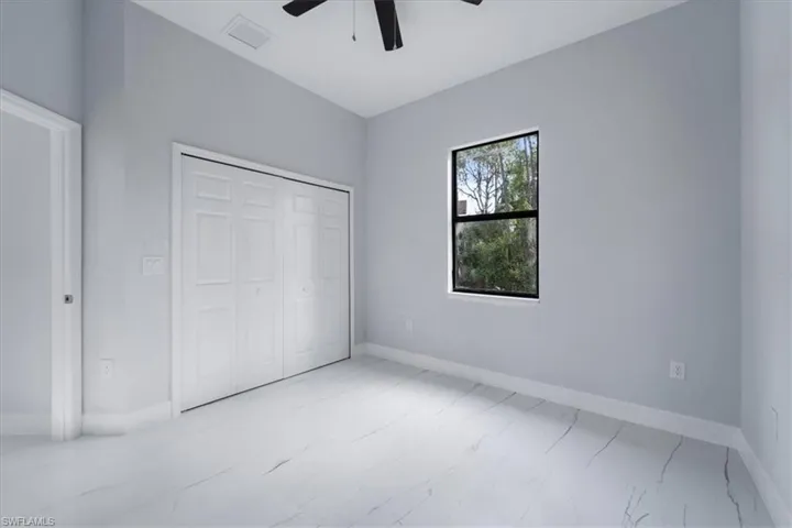 Unfurnished bedroom featuring a closet and ceiling fan