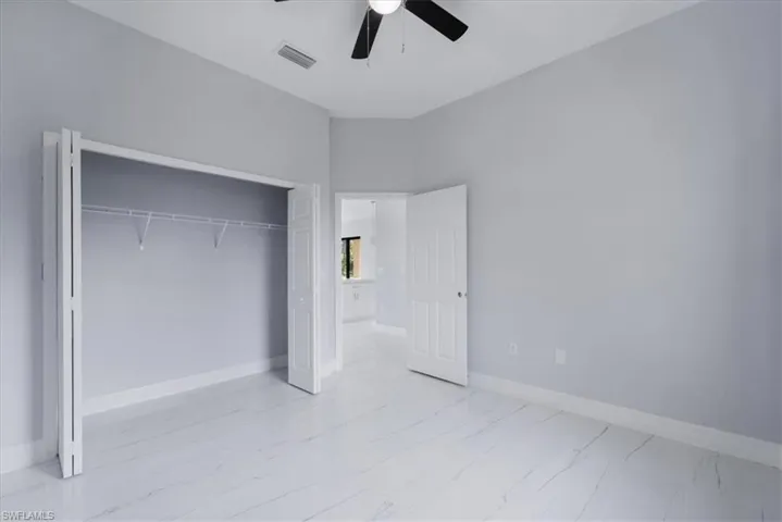 Unfurnished bedroom with a closet and ceiling fan