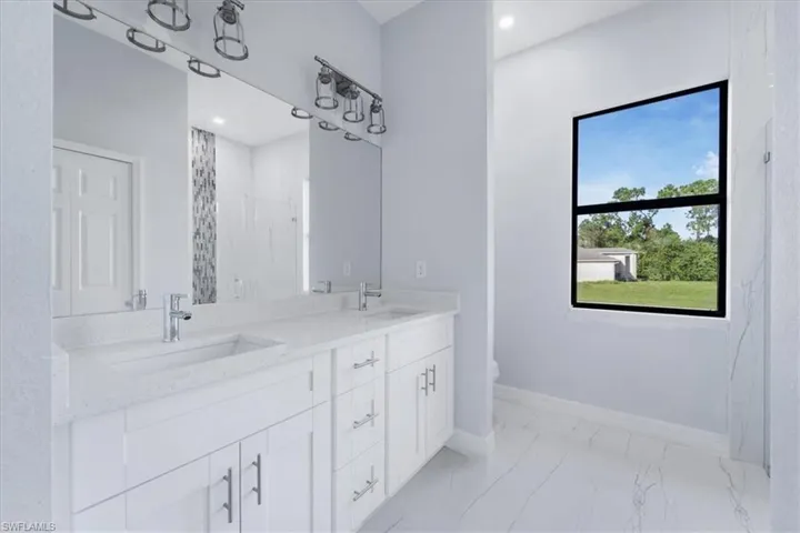 Bathroom with vanity, toilet, and a tile shower