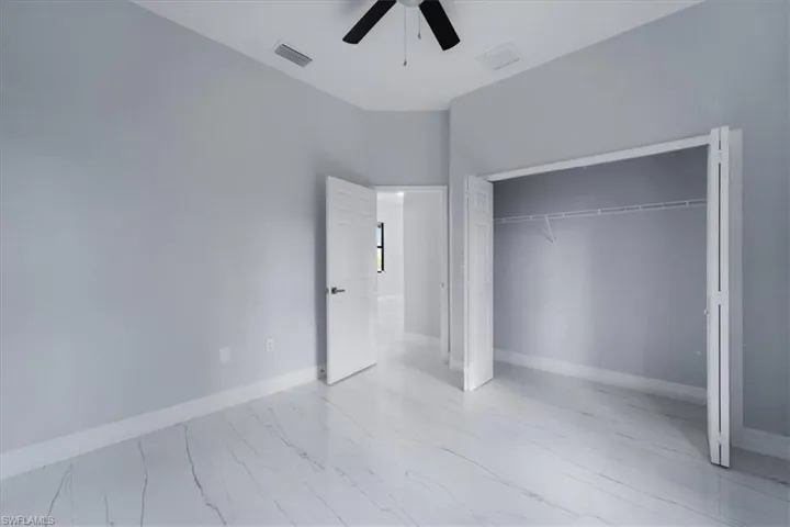 Unfurnished bedroom with a closet and ceiling fan
