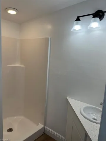 Bathroom with vanity and a stall shower