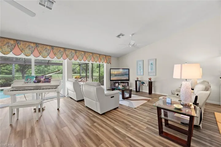 Massive great room with wall of sliders overlooking poo and golf course