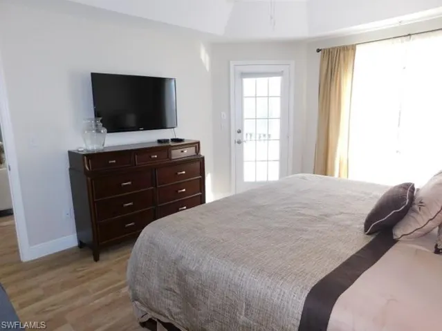 Bedroom featuring light wood-type flooring and baseboards