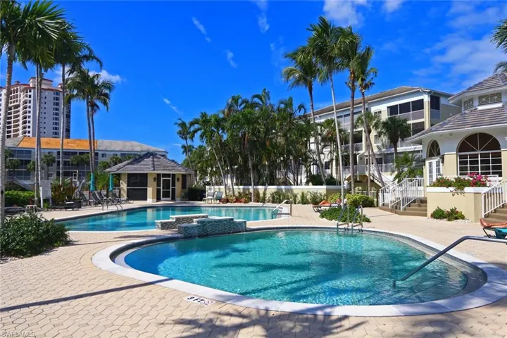 Community pool with a patio area, stairway, and a gazebo