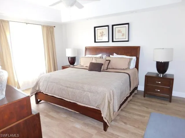 Bedroom with light wood finished floors and a ceiling fan