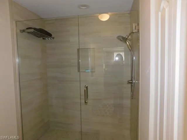 Full bath featuring a shower stall