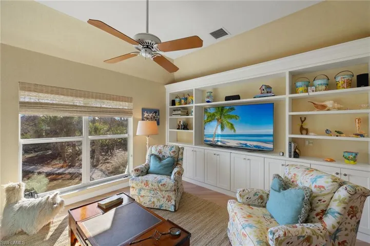 Living room with light hardwood / wood-style flooring and ceiling fan
