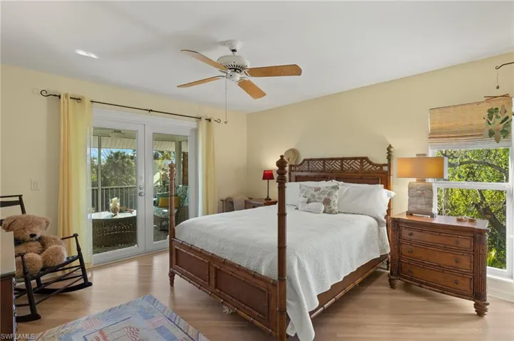 Bedroom with french doors, ceiling fan, access to exterior, and light wood-type flooring
