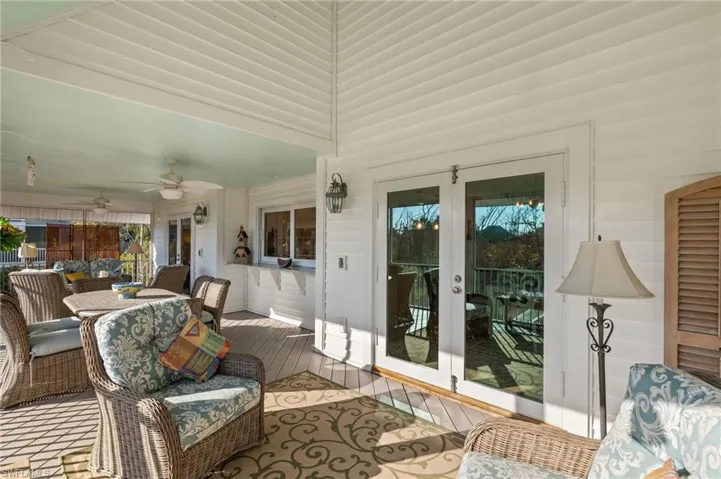 Sunroom featuring french doors and ceiling fan