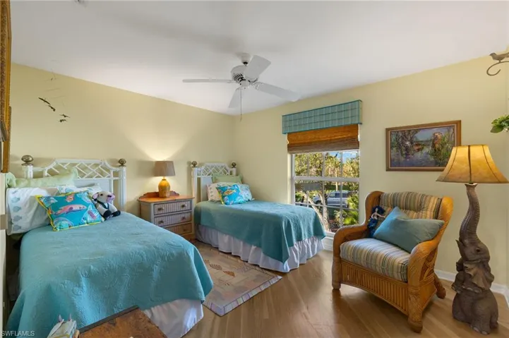 Bedroom with hardwood / wood-style floors and ceiling fan