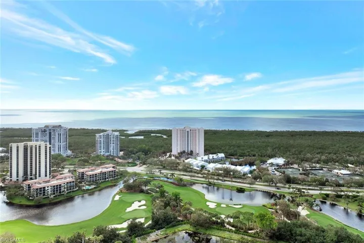 Bird's eye view of a nearby body of water and a golf course