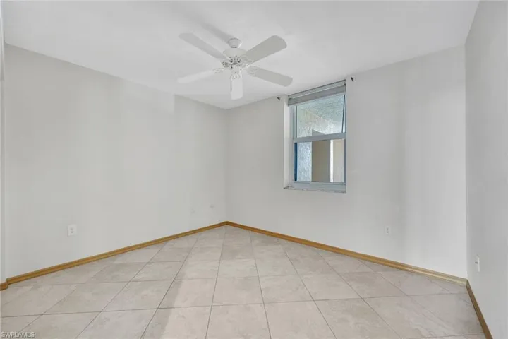 2nd Bedroom with light tile patterned floors and a ceiling fan