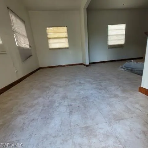 Spare room featuring baseboards