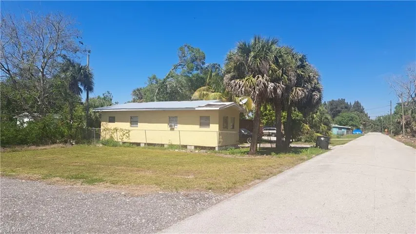 View of side of home featuring a yard