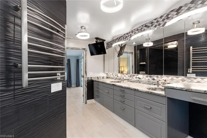 Inlaw Bathroom featuring backsplash, double vanity, and a sink