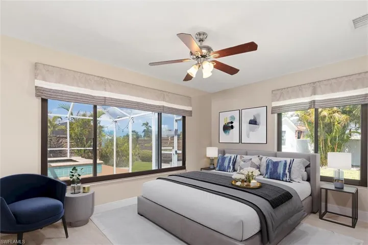 Virtually Staged Bedroom featuring multiple windows, visible vents, baseboards, and a ceiling fan