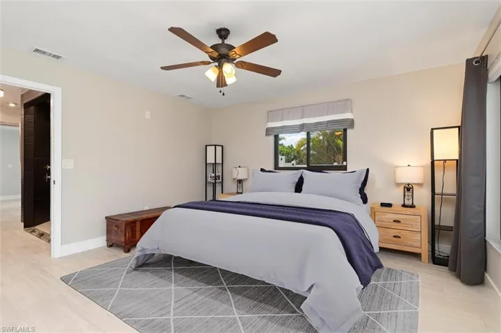 Virtually Staged Bedroom with baseboards, light wood-style flooring, visible vents, and a ceiling fan