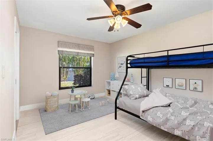 Bedroom featuring baseboards, ceiling fan, and wood finished floors