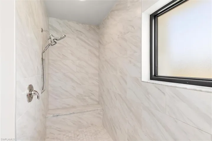 Primary Full bath featuring a tile shower