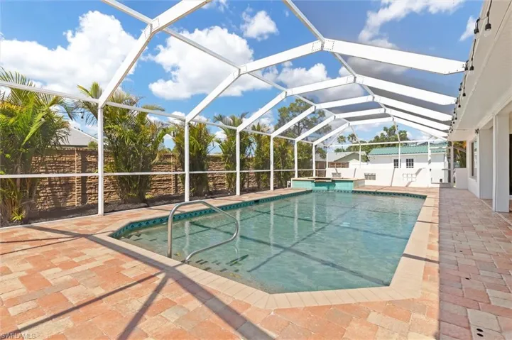 Pool with fence, a lanai, and a patio