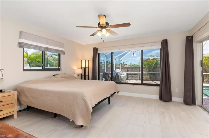Bedroom with baseboards, access to exterior, and ceiling fan