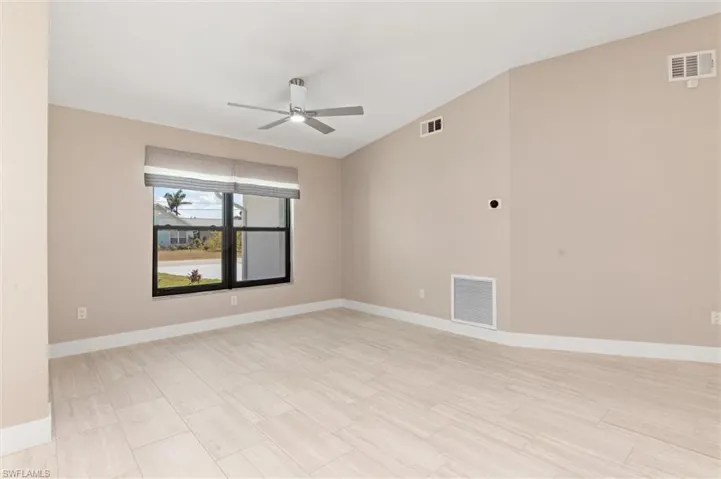 Unfurnished Great room with baseboards, visible vents, and a ceiling fan