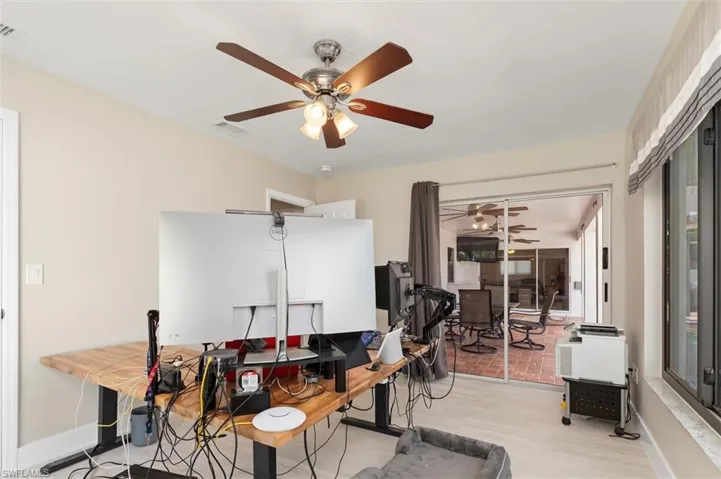 Bedroom/Office area with a ceiling fan, wood finished floors, baseboards, and visible vents