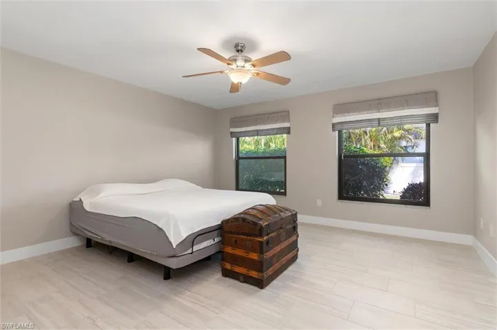 Primary Bedroom featuring baseboards and ceiling fan
