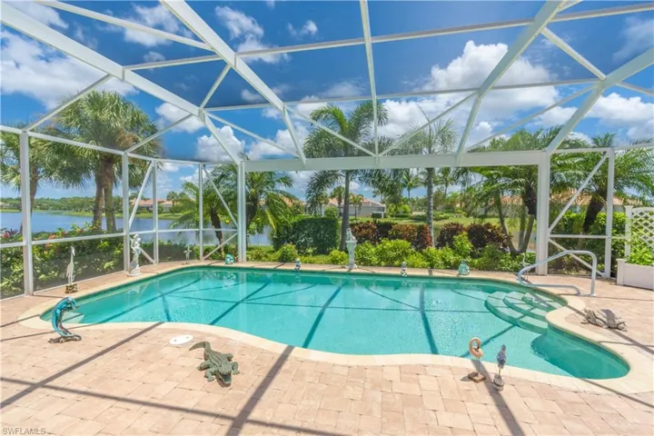 View of swimming pool featuring a patio and glass enclosure