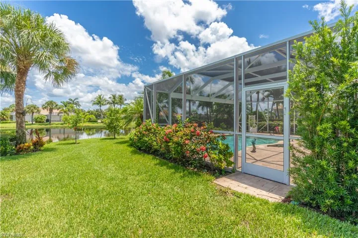View of yard featuring a water view and a lanai