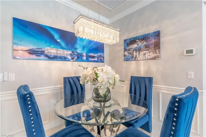 Dining space featuring crown molding and a notable chandelier