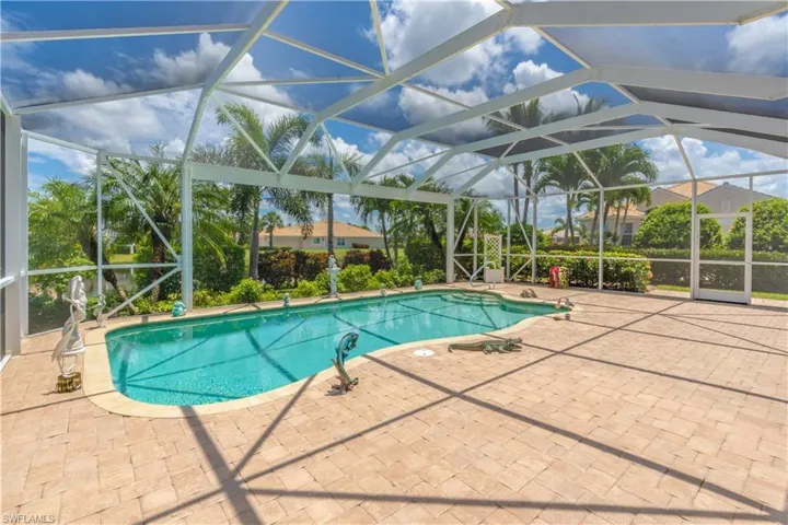 View of pool with a lanai and a patio