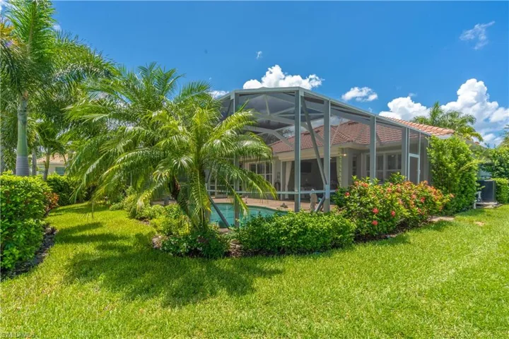 View of yard featuring glass enclosure